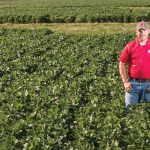 Jason Cavadini standing among a large field
