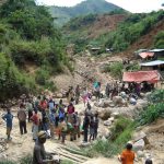 A hilly landscape with lots of people walking around