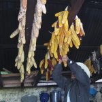 corn tied together, hanging from the ceiling