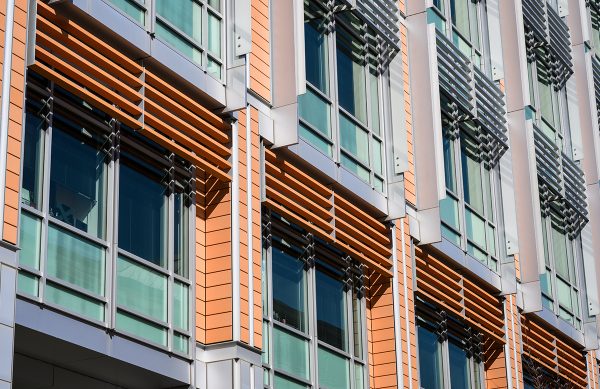 The outside of a building that's covered in many windows. 