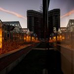 A reflection of the Walnut Street Greenhouses in glass.