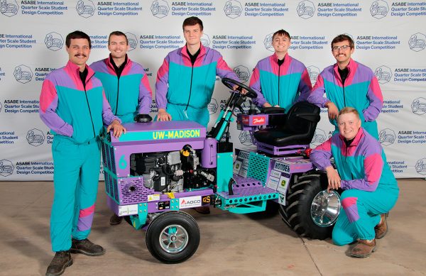 The members of the Pulling Team pose together around their tractor.