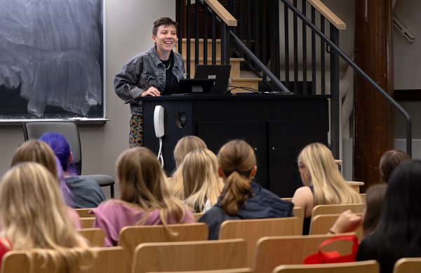 A student stands behind a podium in front of the class.