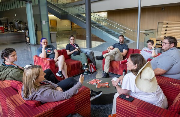 Teachers sit together on couches talking.